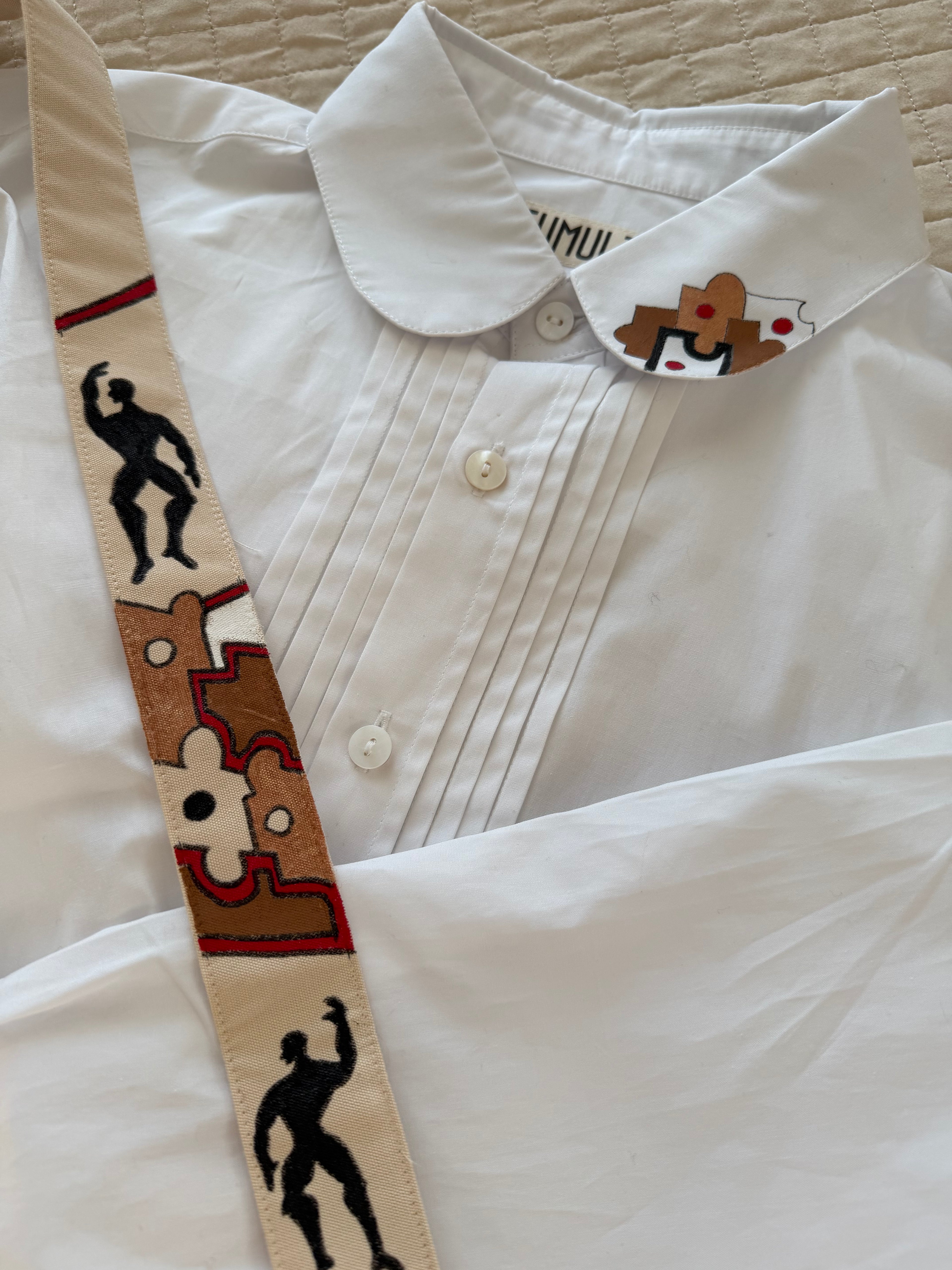 Close-up of textured fabric Puzzle Shirt showcasing handcrafted artisanal detailing and organic textile work