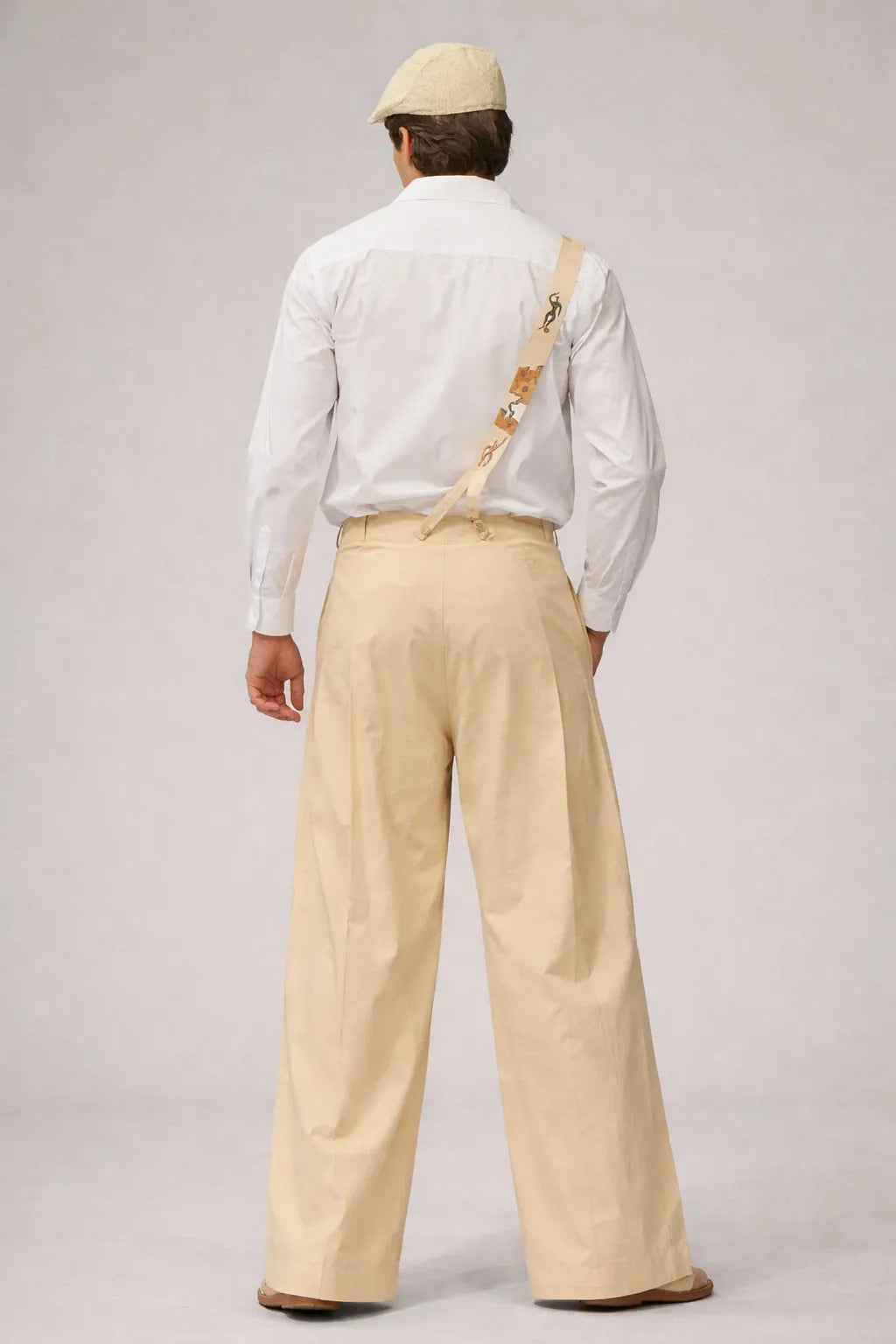 Model wearing Puzzle Plissé Trousers slow fashion artisanal design contemporary style