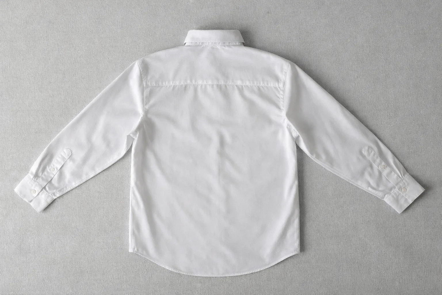 Close-up of textured fabric Puzzle Shirt showcasing handcrafted artisanal detailing and organic textile work